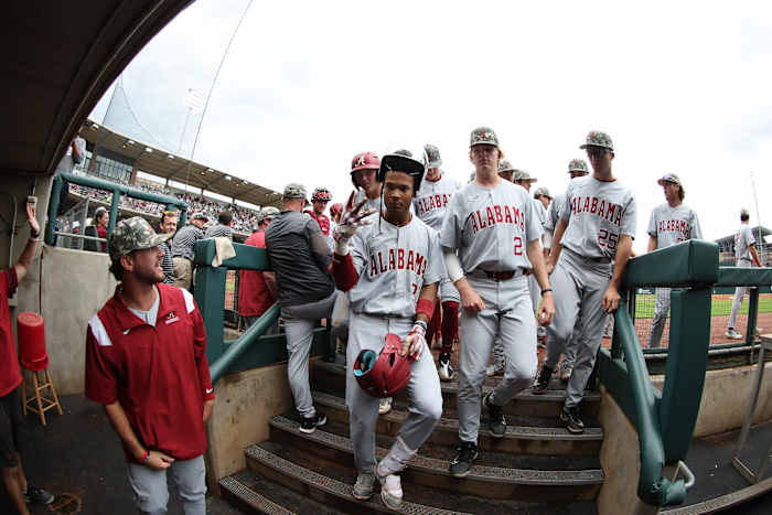 Alabama Baseball's Andrew Pinckney (21) enters the dugout after hitting a home run in the Crimson Tide's 12-1 win over the Texas A&M Aggies on May 13, 2023 at Olsen Field at Blue Bell Park in College Station, Texas.
